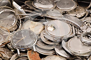 Retro old watches clocks parts pile heap closeup