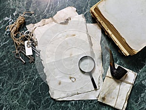 Retro papers and book on detective work table with tools