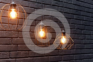 Retro pattern with copy space. Beautiful mysterious glass yellow orange electric incandescent lamp emitting light in the dark, on