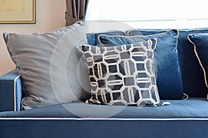 Retro pattern, gray and blue pillow setting up on sofa