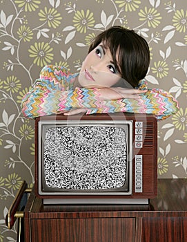 Retro pensive woman on vintage wooden tv 60s
