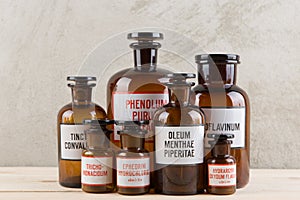 Retro pharmacy - vintage pharmacy bottles on wooden board photo