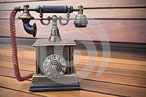Retro Phone model, vintage old dial Telephone on wood background
