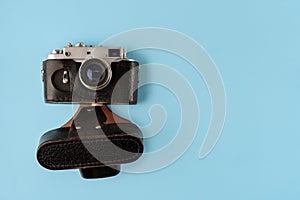 Retro photo camera on blue background, top view