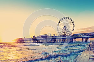 RETRO PHOTO FILTER EFFECT: Blackpool Central Pier at Sunset with Ferris Wheel, Lancashire, England UK