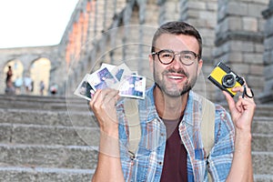 Retro photographer holding instant pics