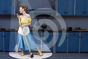 Retro pin up girl housewife holding mop singing and cleaning floor