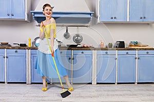 Retro pin up girl housewife in the kitchen