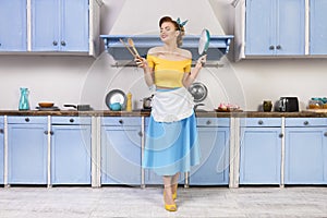 Retro pin up woman housewife sitting in the kitchen