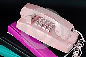 Retro Pink Telephone on Books