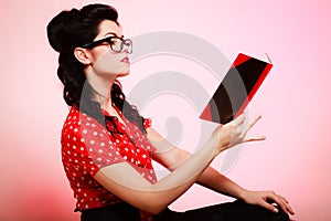 Retro. Pinup girl in eyeglasses reading book