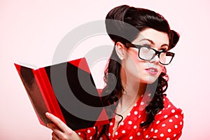 Retro. Pinup girl in eyeglasses reading book