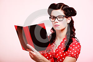 Retro. Pinup girl in eyeglasses reading book