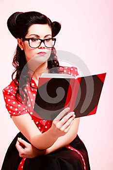 Retro. Pinup girl in eyeglasses reading book