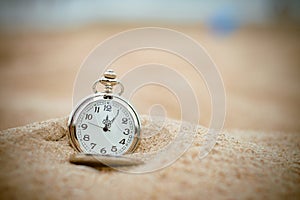 Retro pocket watch on the beach