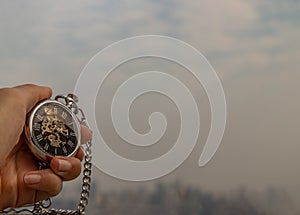 A retro pocket watch with chain in the palm of the girl`s hand