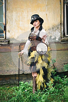 retro portrait of a beautiful woman with a clock in her hands. steampunk style.