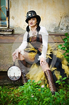 retro portrait of a beautiful woman with a clock in her hands. steampunk style.