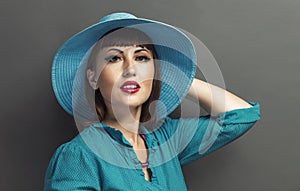 Retro portrait of a beautiful woman with hat. Vintage style. Fashion photo
