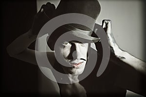 Retro portrait of theatrical actor with a hat