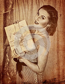 Retro portrait of woman keeps gift box.