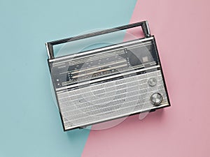 Retro radio receiver on a pink blue pastel background. Media technology 60s.
