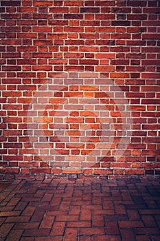 Retro red brick wall and brick floor.