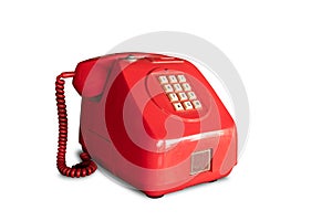 Retro red pay phone operated by coins isolated on white background with clipping path.