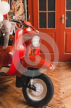 Retro red scooter  in oldschool vintage interior with air balloons.