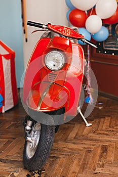 Retro red scooter  in oldschool vintage interior with air balloons.