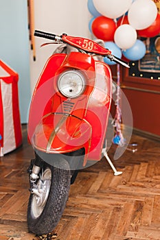 Retro red scooter  in oldschool vintage interior with air balloons.