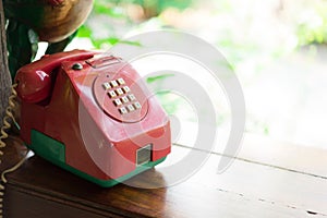 Retro red telephone on wood table