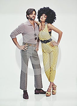 Retro romance. An attractive young couple standing together in retro 70s clothing.
