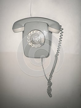 Retro rotary dial phone hanging on the wall