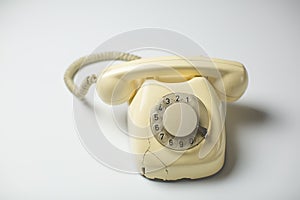 Retro rotary telephone with cracks and broken parts