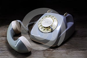 Retro rotary telephone with rotary dial and removed receiver on