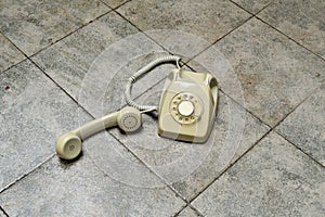 Retro rotary telephone on a tiled floor