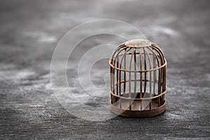 Retro rusty cage on dark wooden background