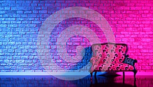 Retro sofa on the background of an old brick wall in the enon light
