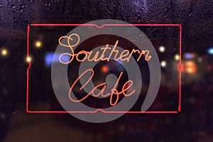 Retro Southern Cafe Neon Sign in Rainy Window