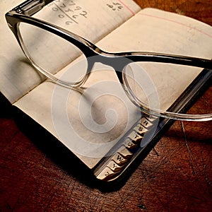 Retro spectacles with little black book. photo