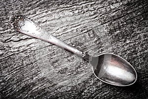 Retro spoon on the old wooden table. Toned