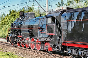 Retro steam freight train departs from the railway station. Moscow.