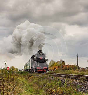 Retro steam train approaches mountains