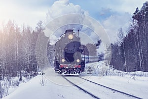 Retro steam train moves at winter morning