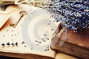 Retro still life with vintage books, key and lavender flowers, nostalgic composition. photo