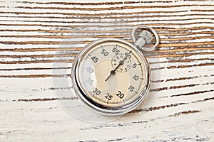 Retro stopwatch on rustic background