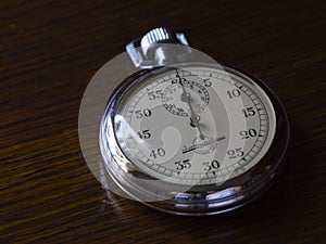 Retro stopwatch is on a wooden table