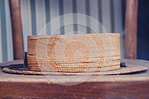 Retro straw hat left on an old bench, close-up