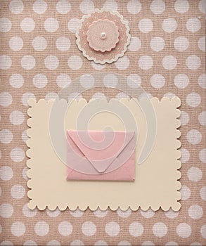 Retro style album page with mail envelope and flower decoration on vintage polka dot pattern textile